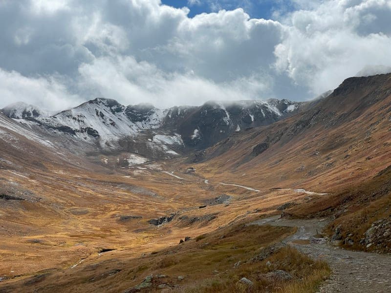 A high basin under snow-streaked peaks, empty and quiet.