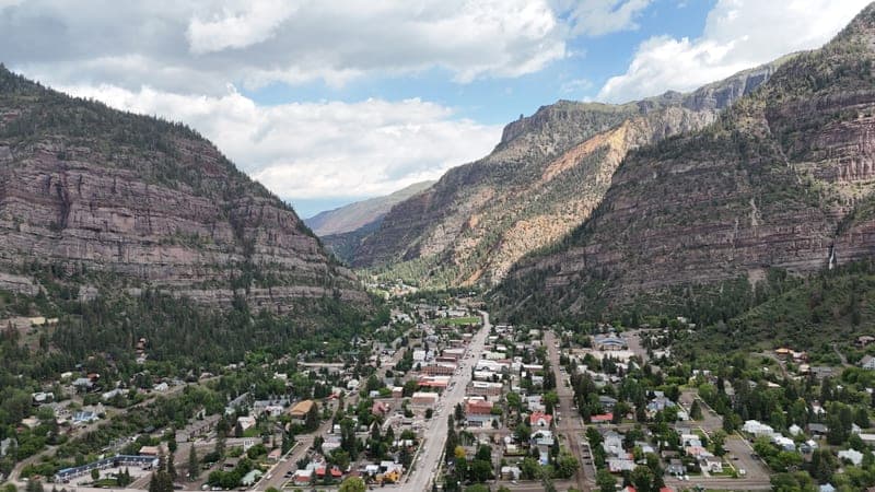A mountain town spread along a valley floor, seen from above.